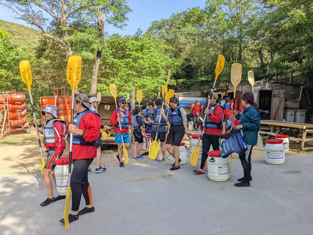 A group is getting ready to go on a canoe kayak excursion